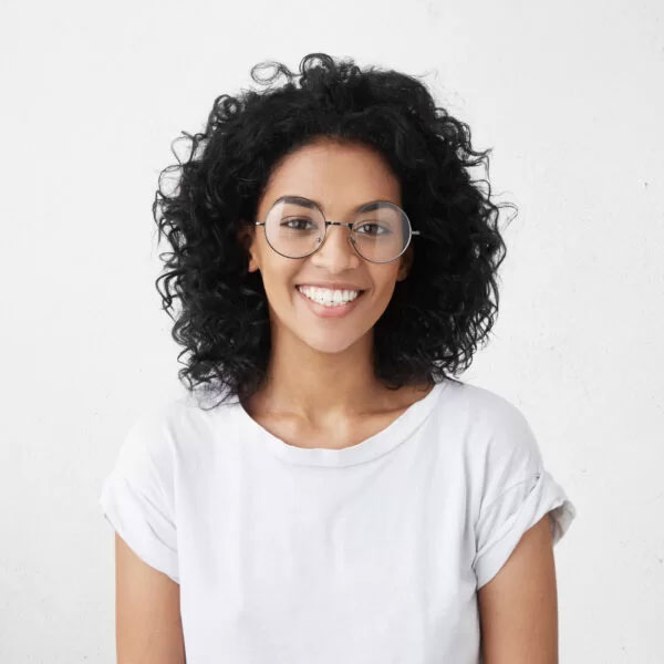 woman wearing big round glasses smiling