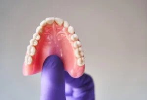 Teeth on dentist hand